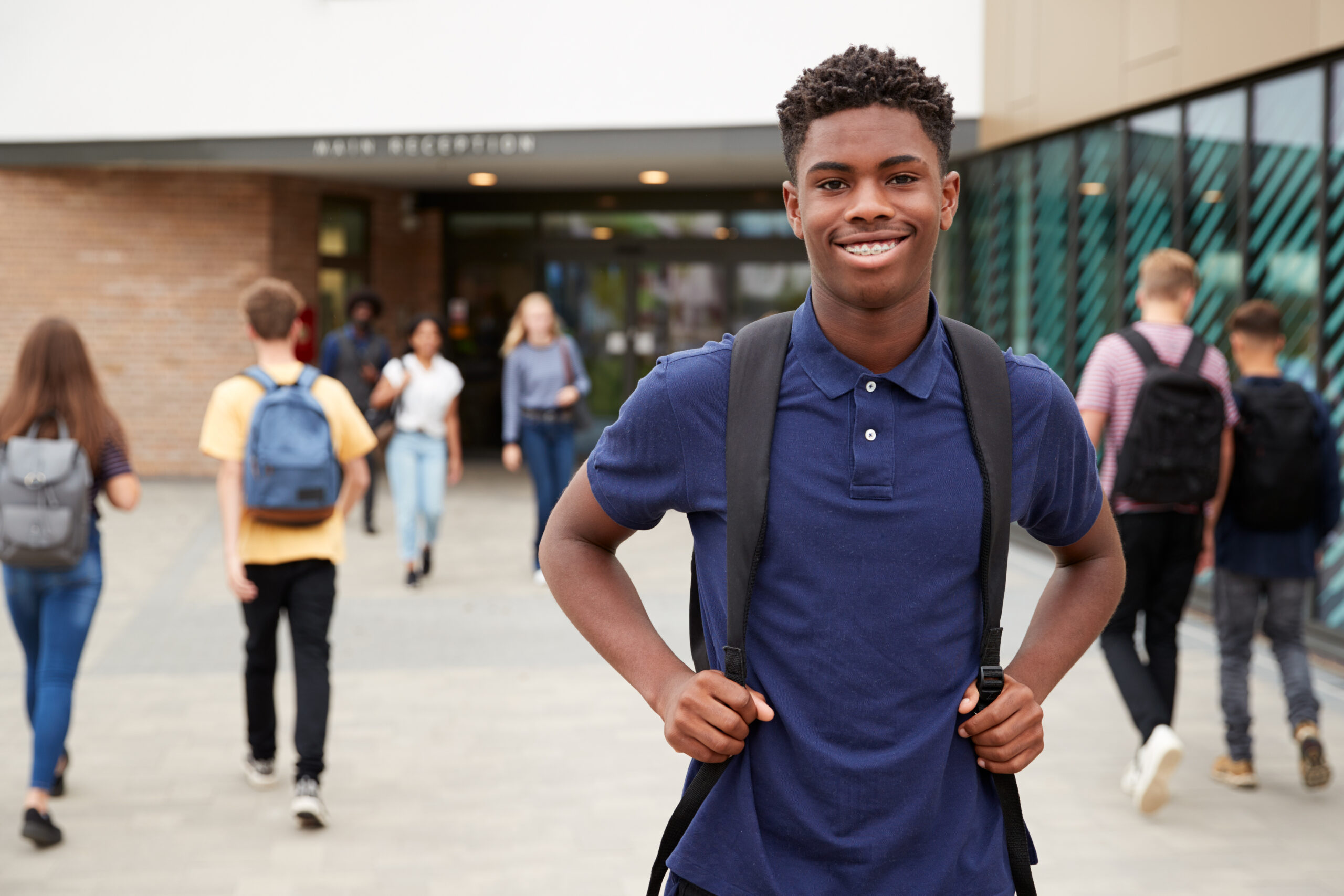 Portrait,Of,Smiling,Male,High,School,Student,Outside,College,Building